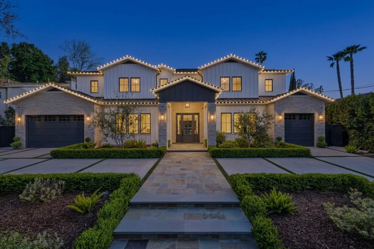 The same house rendered at night with warm white lighting on every traced run